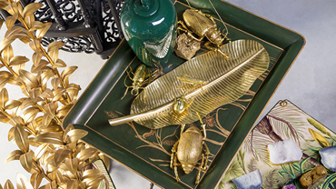 Gold-colored jewelry and decorative elements on a green shell